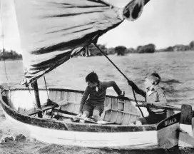 Two people sailing a small boat.